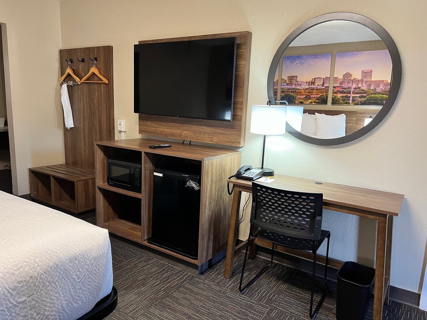 Days Inn Monroe room amenities — TV, microwave, mini fridge, and Charlotte skyline artwork